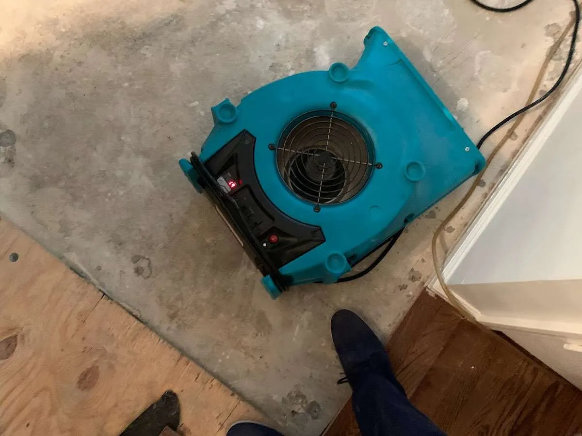 Air mover drying subfloor during Commercial Water Damage Restoration in Lake City